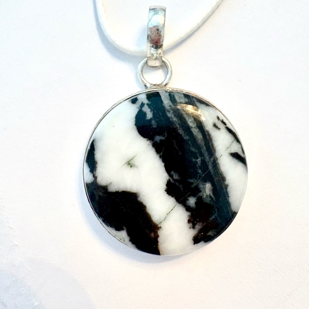 Beautiful, 1 inch, White Buffalo Turquoise pendant on a white leather chain.